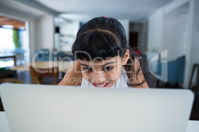 Smiling girl using laptop