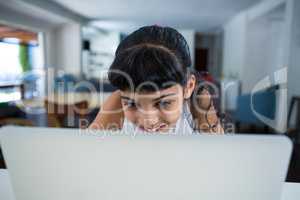 Smiling girl using laptop