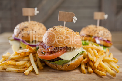 Various hamburger with tag and french fries on wooden table