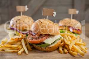 Various hamburger with tag and french fries on wooden table