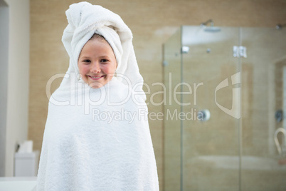 Portrait of smiling girl wrapped in towel