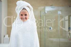 Portrait of smiling girl wrapped in towel