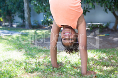 Portrait of girl practicing handstand