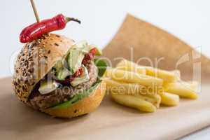 Close up of hamburger with jalapeno by French fries