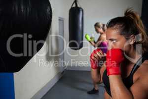 Women practicing boxing in fitness studio