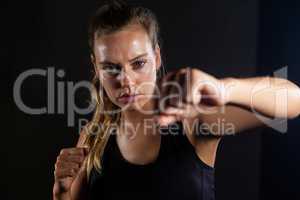 Woman practicing boxing in fitness studio