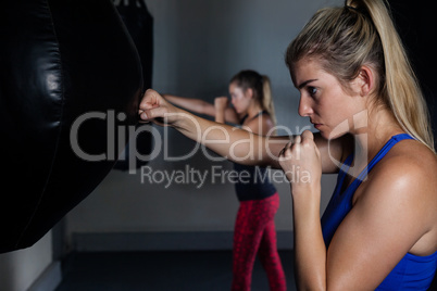 Women practicing boxing in fitness studio