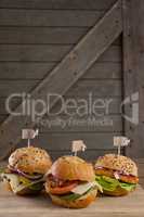 Various hamburger with tag on wooden table