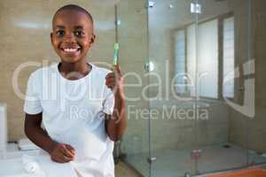 Portrait of smiling boy holding toothbrush