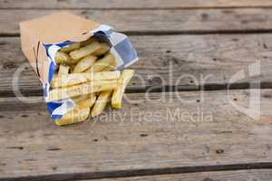 Close up of French fries in container on table