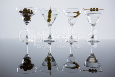 Cocktail martini with olives on table