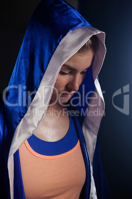 Determined woman wearing boxing robe