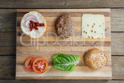 Sliced vegetables ingredient for making hamburger on chopping board