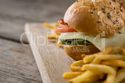 Close up of cheeseburger with french fries