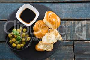 Marinated olives with bread pieces and olive oil