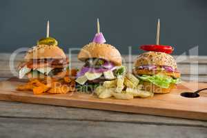 Close up of various burgers on cutting board