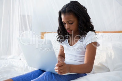 Girl using laptop at home