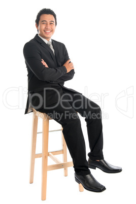 Full body Asian businessman arm crossed sitting on chair