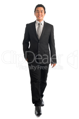 Smart Southeast Asian businessman walking