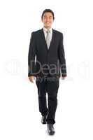 Asian businessman walking