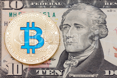 Golden cryptocurrency blue bitcoin on ten dollar banknote backgr
