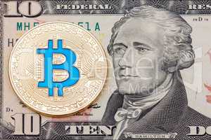 Golden cryptocurrency blue bitcoin on ten dollar banknote backgr