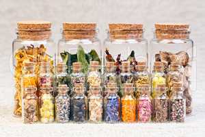 Healing herbs and tinctures in bottles on sackcloth, dried flowe