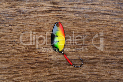 Fishing lure on the old wooden table.