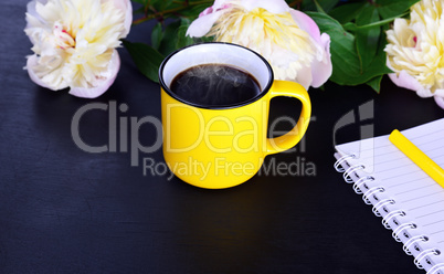 Hot black coffee in a yellow mug