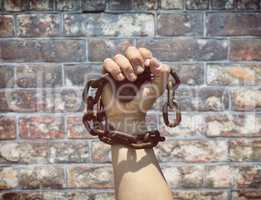 man's hand is wrapped in a metal chain