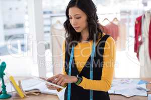 Fashion designer using digital tablet