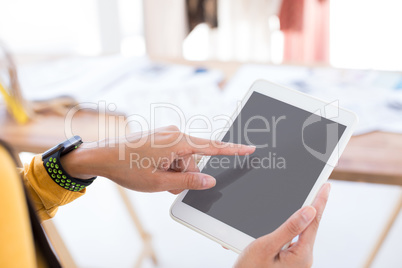 Fashion designer using digital tablet in office