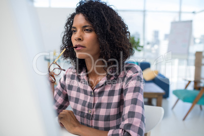 Female executive working on computer at desk