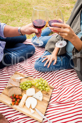 Cropped image of couple toasting wineglasses