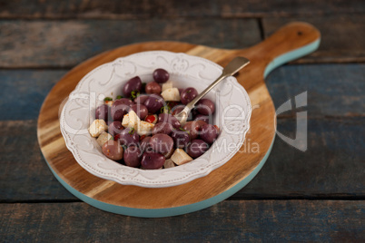 Close up of black olives served in plate on tray