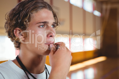 Close up of basketball coach whistling