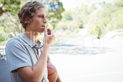 Man with basketball whistling