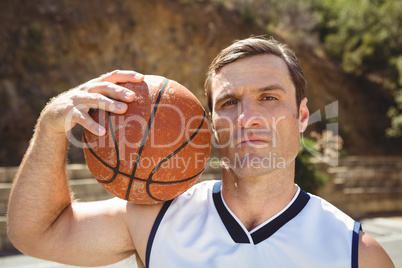 Confident basketball player with ball