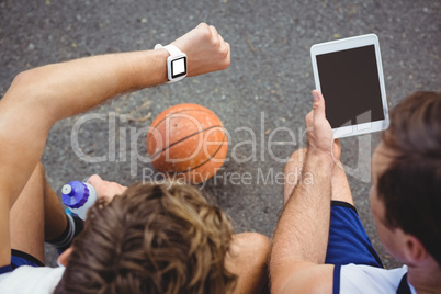 Overhead view of basketball players using technologies Overhead view of basketball players using technologies