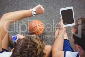 Overhead view of basketball players using technologies