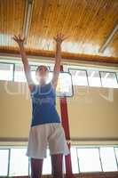 Low angle view of woman playing basketball