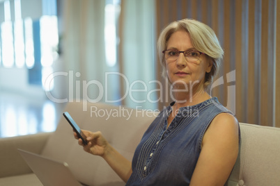 Portrait of businesswoman with smartphone