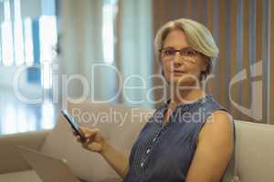 Portrait of businesswoman with smartphone