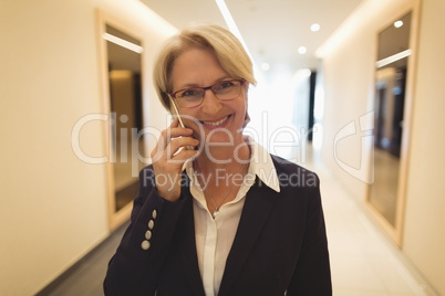 Smiling businesswoman talking on phone