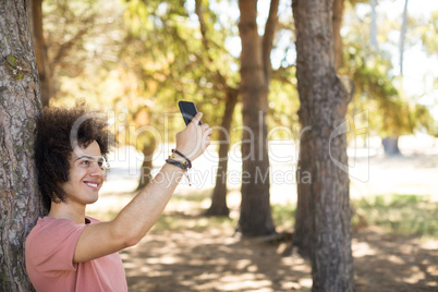 Smiling taking selfie at forest