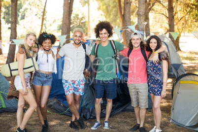 Portrait of smiling friends at campsite