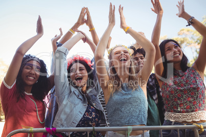 Low angle view of cheerful female fans enjoying music festival