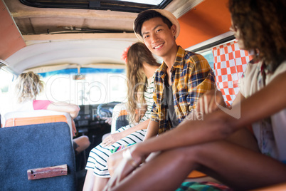 Portrait of smiling man with friends in camper van