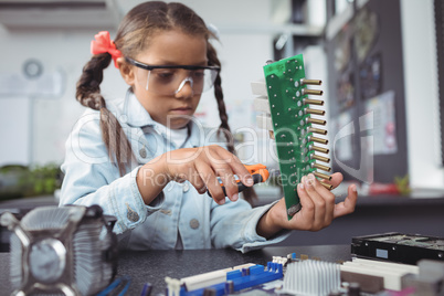 Concentrated elementary girl assembling circuit board