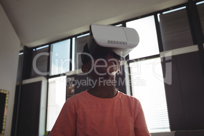 Low angle view of boy wearing virtual reality simulator